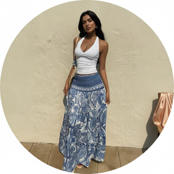 Circular portrait of Leona Rossi, a woman with a relaxed expression, wearing the flowing BOHELIA maxi skirt. Clean background